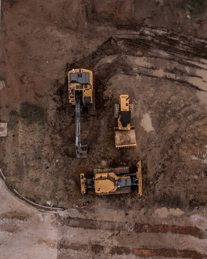 Aerial Photo Of Excavator, Road Roller, And Bulldozer